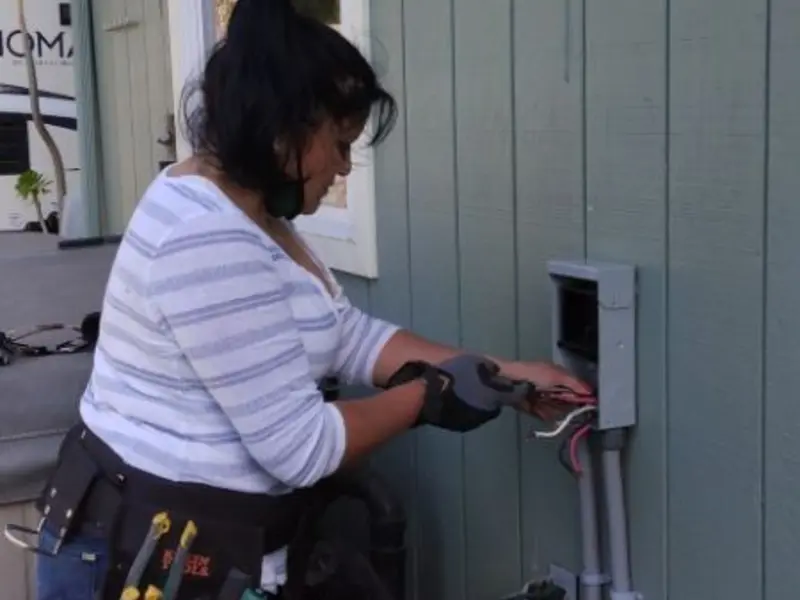Licensed electrician wiring an exterior subpanel in Orting
